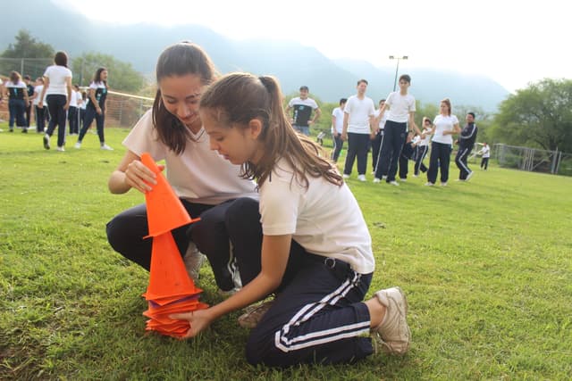 Niños participando en juegos grupales, fomentando la convivencia y el compañerismo en un entorno natural.